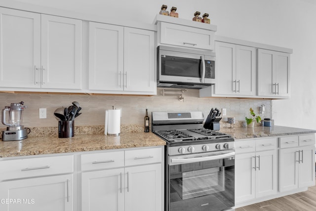12614 Amesbury, El Paso, TX 79928 - kitchen with stainless steel appliances, light stone countertops, and white cabinets