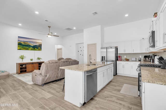 12614 Amesbury, El Paso, TX 79928 - kitchen featuring appliances with stainless steel finishes, a sink, open floor plan, a ceiling fan, and white cabinets