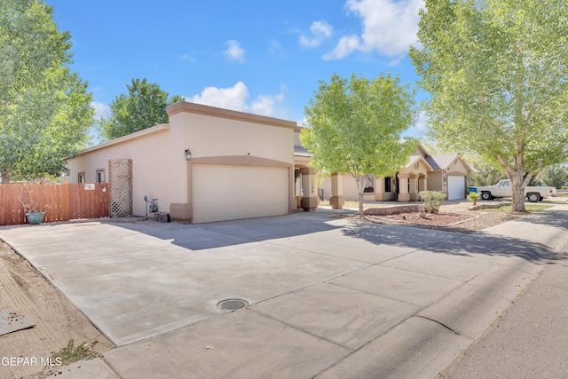 11590 Flor Liatris Dr, Socorro, TX 79927 - view of front of property featuring stucco siding, concrete driveway, and a garage