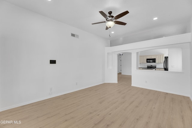 11590 Flor Liatris Dr, Socorro, TX 79927 - unfurnished living room with light wood-type flooring, recessed lighting, ceiling fan, baseboards, and arched walkways