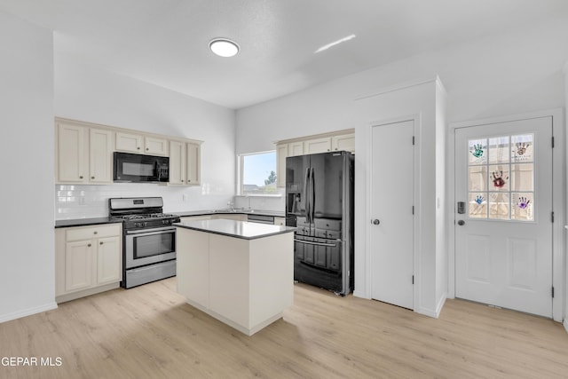 11590 Flor Liatris Dr, Socorro, TX 79927 - kitchen with black appliances, decorative backsplash, light wood-style floors, and a sink