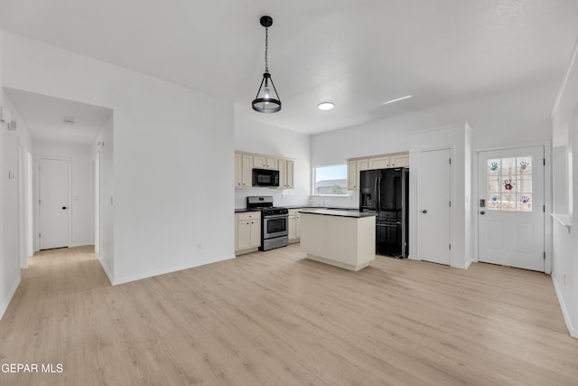 11590 Flor Liatris Dr, Socorro, TX 79927 - kitchen with black appliances, light wood-style flooring, a kitchen island, and baseboards