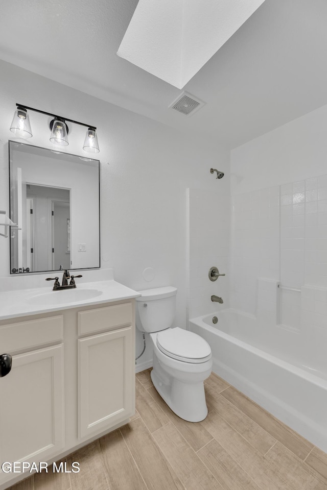 11590 Flor Liatris Dr, Socorro, TX 79927 - bathroom with toilet, vanity, shower / tub combination, and wood finished floors
