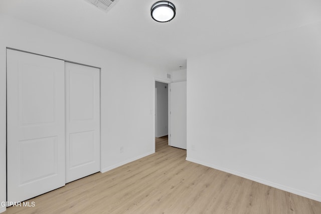 11590 Flor Liatris Dr, Socorro, TX 79927 - unfurnished bedroom with wood finished floors, baseboards, and a closet