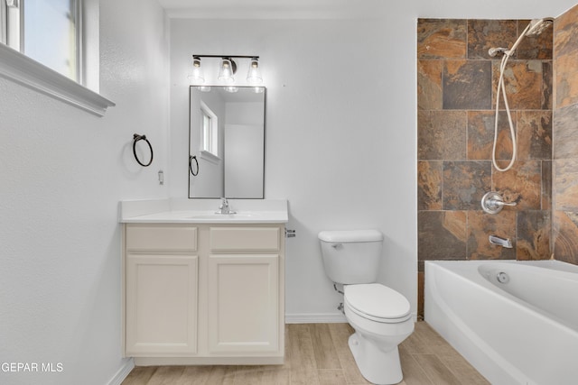 11590 Flor Liatris Dr, Socorro, TX 79927 - bathroom featuring toilet, vanity, tub / shower combination, baseboards, and wood finished floors