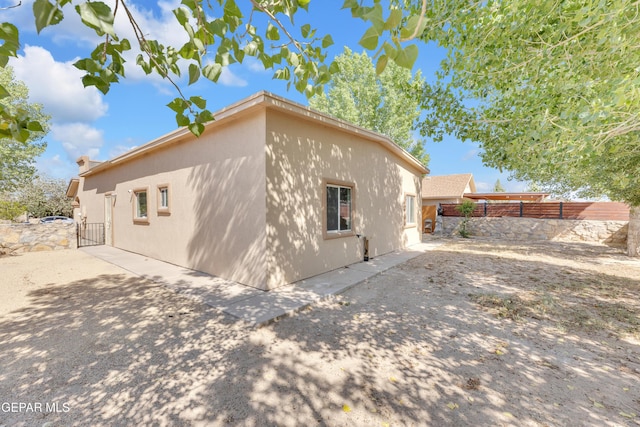 11590 Flor Liatris Dr, Socorro, TX 79927 - view of home's exterior with stucco siding and a patio area