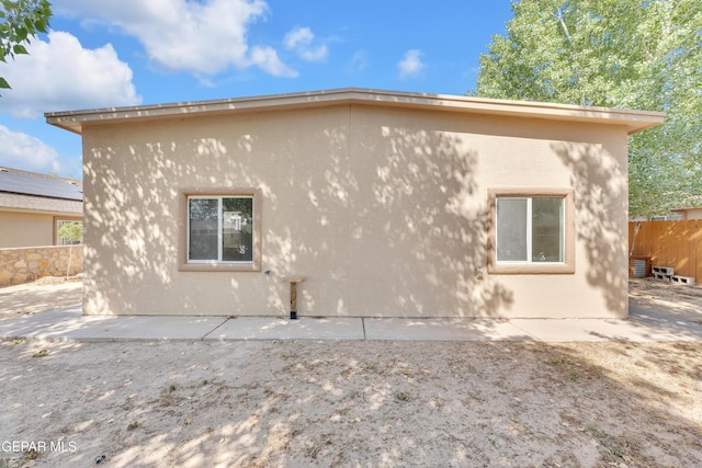 11590 Flor Liatris Dr, Socorro, TX 79927 - view of side of home with stucco siding and a patio area
