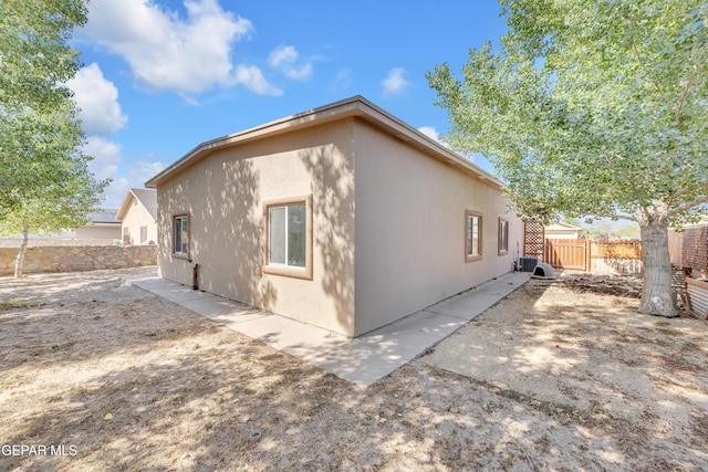 11590 Flor Liatris Dr, Socorro, TX 79927 - view of home's exterior featuring a fenced backyard, cooling unit, stucco siding, and a patio area