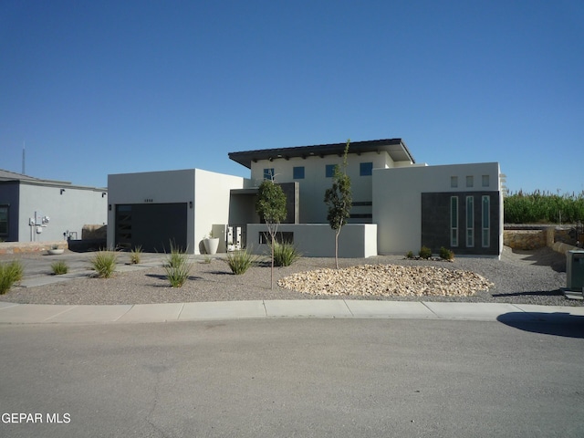 5868 Valley Palm Dr, El Paso, TX 79932 - contemporary house featuring an attached garage and stucco siding