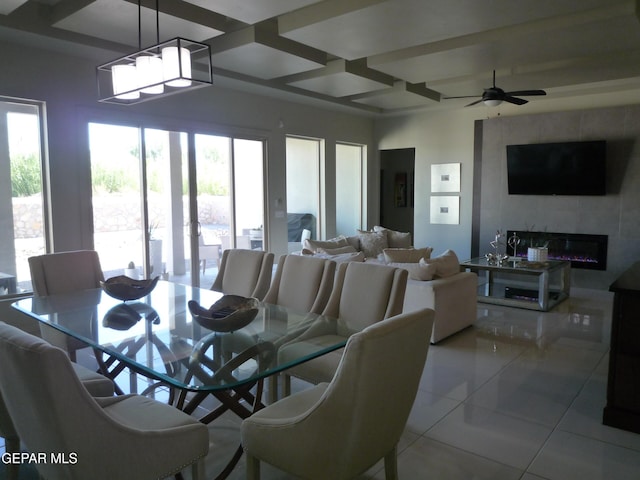 5868 Valley Palm Dr, El Paso, TX 79932 - tiled dining room with coffered ceiling, a glass covered fireplace, a ceiling fan, and beam ceiling
