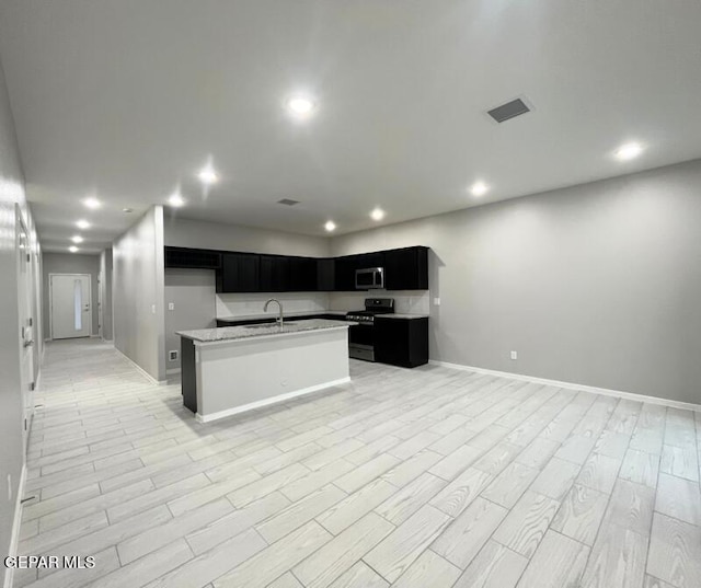 3800 Surmise St, El Paso, TX 79938 - kitchen with appliances with stainless steel finishes, dark cabinetry, a sink, open floor plan, and baseboards