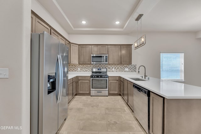 1741 Breeder Cup Way, El Paso, TX 79928 - kitchen featuring stainless steel appliances, a sink, a peninsula, backsplash, and light countertops