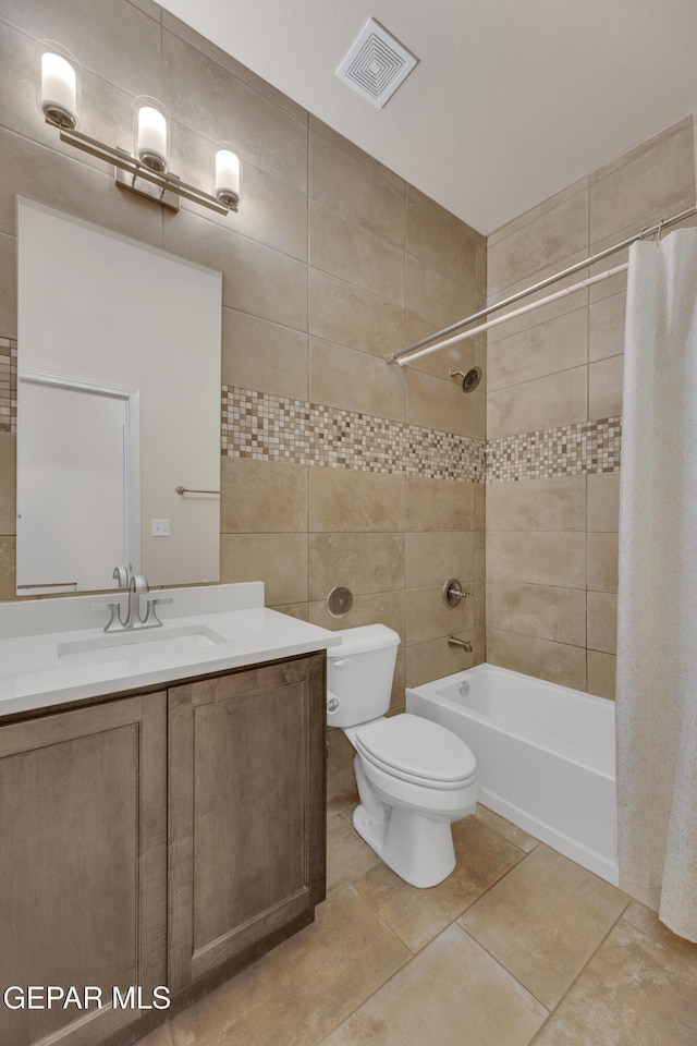 1741 Breeder Cup Way, El Paso, TX 79928 - full bathroom featuring tile walls, vanity, toilet, shower / tub combo with curtain, and tile patterned floors