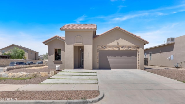 1741 Breeder Cup Way, El Paso, TX 79928 - mediterranean / spanish-style house featuring a garage, concrete driveway, stucco siding, and a tiled roof