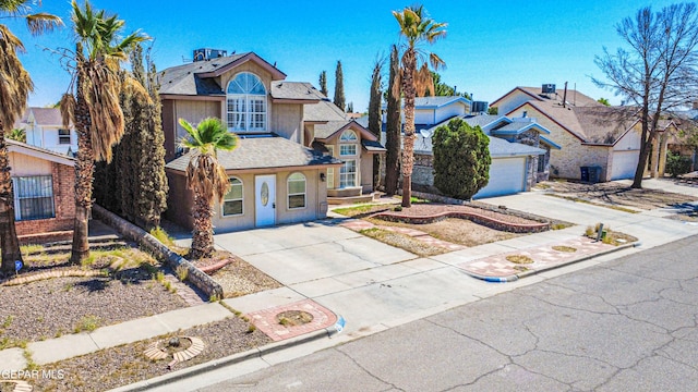 11513 Cree Ct, El Paso, TX 79936 - traditional-style house with concrete driveway, stucco siding, a residential view, and a shingled roof