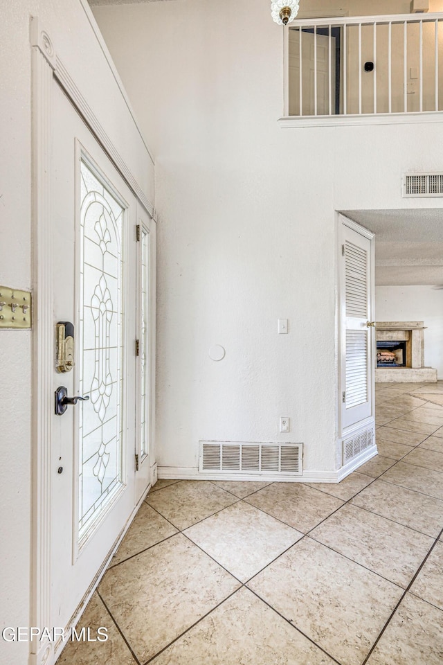 11513 Cree Ct, El Paso, TX 79936 - tiled entrance foyer featuring baseboards and a fireplace with raised hearth