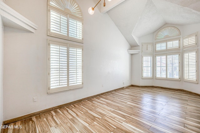 11513 Cree Ct, El Paso, TX 79936 - unfurnished room featuring wood finished floors, lofted ceiling, baseboards, and a textured ceiling