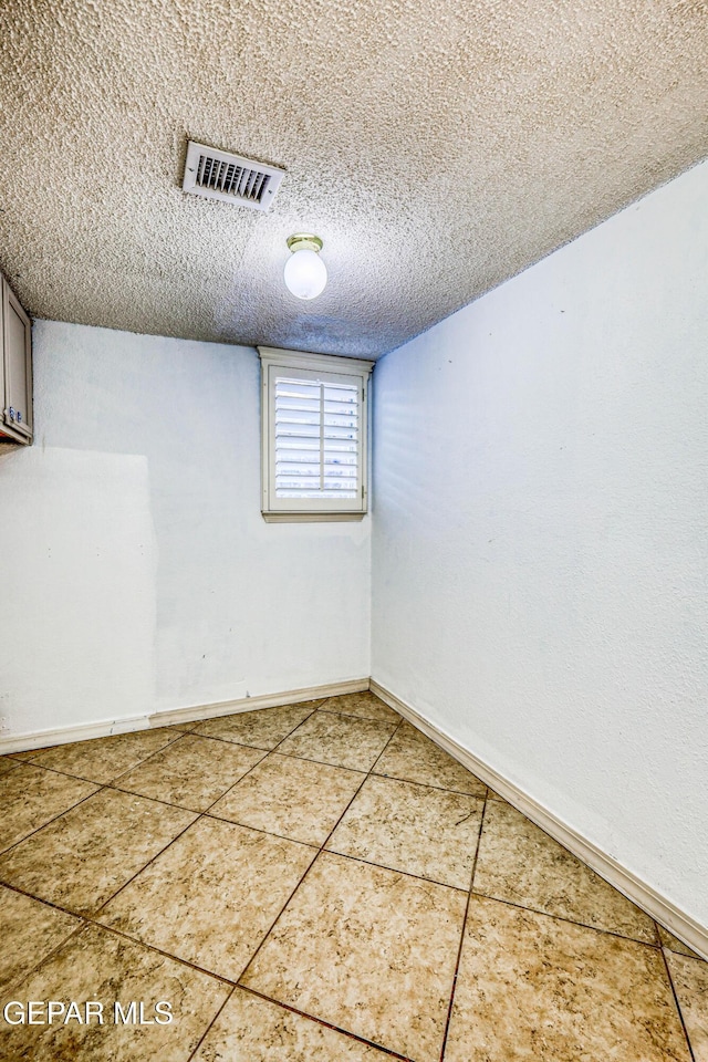 11513 Cree Ct, El Paso, TX 79936 - below grade area featuring baseboards, a textured ceiling, and tile patterned flooring