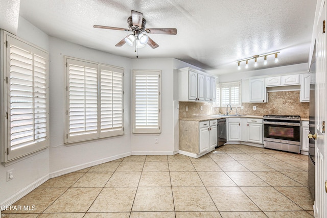 11513 Cree Ct, El Paso, TX 79936 - kitchen featuring stainless steel appliances, a textured ceiling, light countertops, ceiling fan, and decorative backsplash