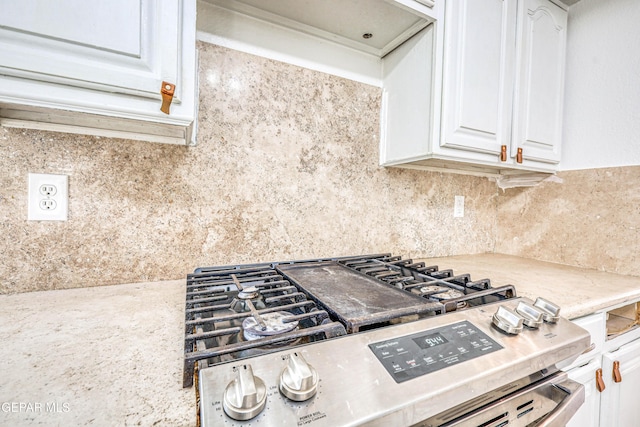 11513 Cree Ct, El Paso, TX 79936 - kitchen with white cabinets, gas stove, tasteful backsplash, and light stone counters