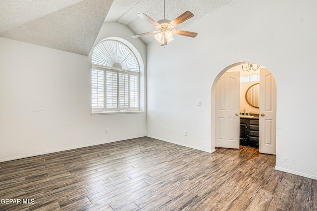 11513 Cree Ct, El Paso, TX 79936 - empty room featuring arched walkways, ceiling fan, lofted ceiling, wood finished floors, and a textured ceiling