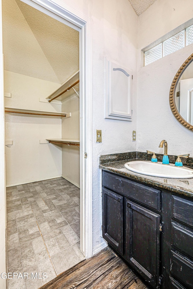 11513 Cree Ct, El Paso, TX 79936 - bathroom featuring vanity and a textured ceiling