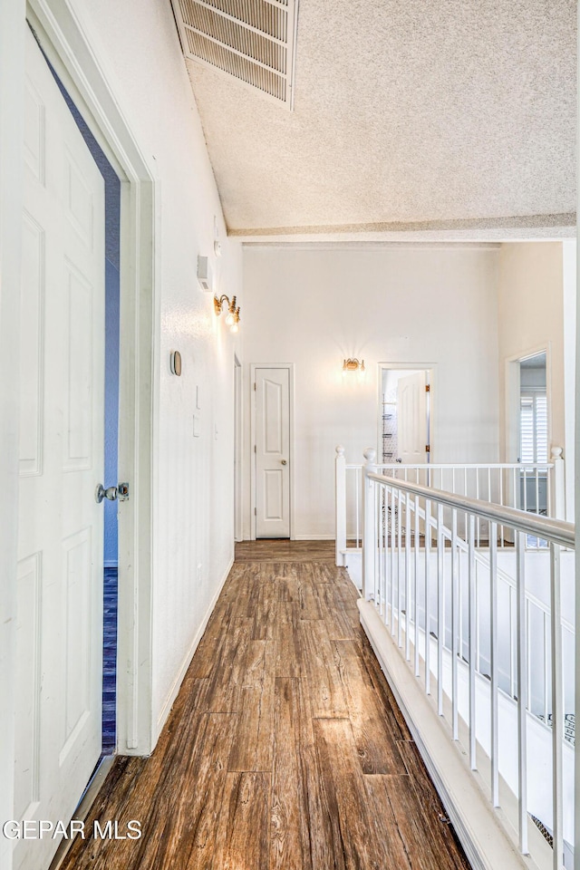11513 Cree Ct, El Paso, TX 79936 - hall with a textured ceiling, wood finished floors, an upstairs landing, and baseboards