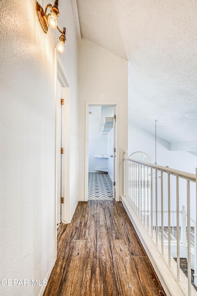11513 Cree Ct, El Paso, TX 79936 - corridor with wood finished floors, a textured ceiling, and lofted ceiling
