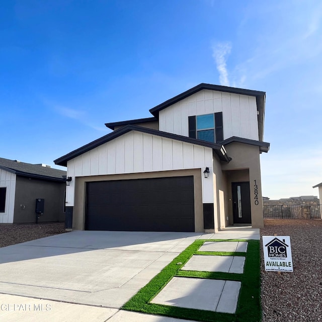 3804 Surmise St, El Paso, TX 79928 - view of front of property with a garage, driveway, and board and batten siding