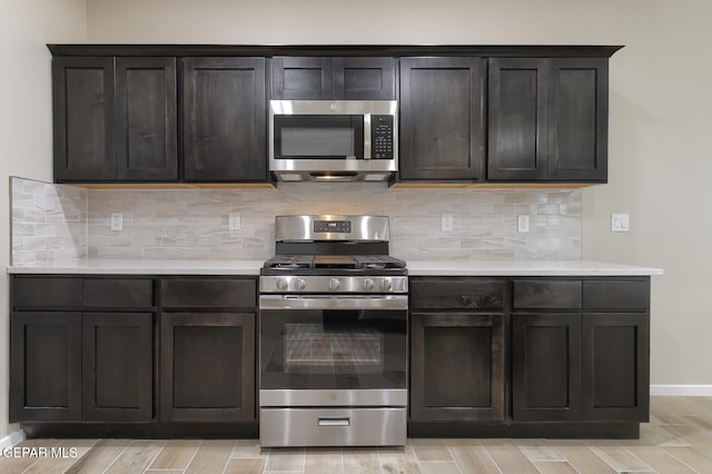 3804 Surmise St, El Paso, TX 79928 - kitchen featuring appliances with stainless steel finishes, light countertops, baseboards, light wood-style floors, and backsplash