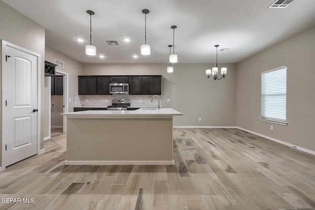 3804 Surmise St, El Paso, TX 79928 - kitchen featuring appliances with stainless steel finishes, a sink, light wood-type flooring, light countertops, and recessed lighting