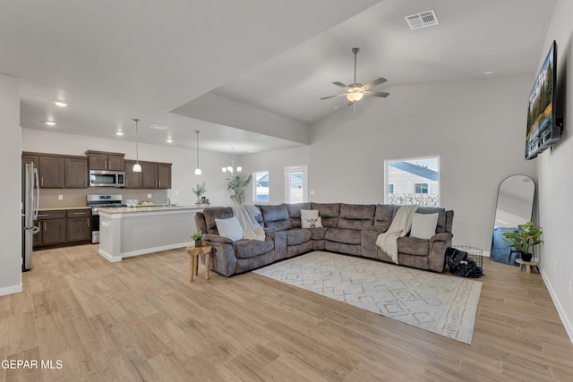 13676 Lago Vista Ave, Horizon City, TX 79928 - living room with a ceiling fan, light wood finished floors, and lofted ceiling