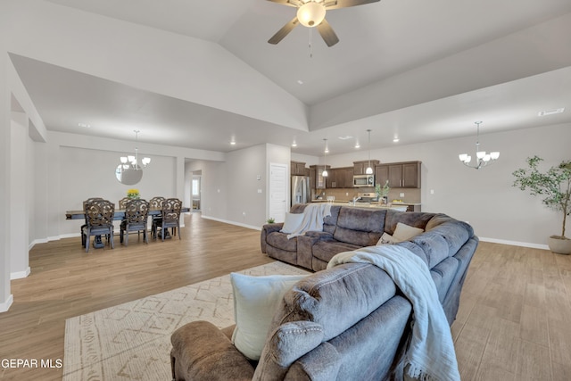 13676 Lago Vista Ave, Horizon City, TX 79928 - living room with a chandelier, light wood-style flooring, baseboards, vaulted ceiling, and recessed lighting