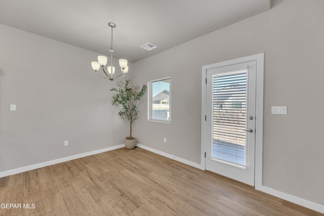 13676 Lago Vista Ave, Horizon City, TX 79928 - spare room with light wood-type flooring, a chandelier, and baseboards