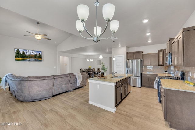 13676 Lago Vista Ave, Horizon City, TX 79928 - kitchen featuring stainless steel appliances, a chandelier, open floor plan, a sink, and light wood-type flooring