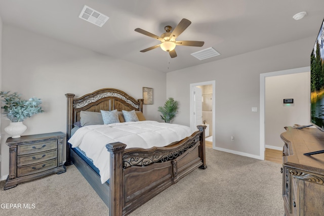 13676 Lago Vista Ave, Horizon City, TX 79928 - bedroom with light colored carpet, baseboards, a ceiling fan, and ensuite bath