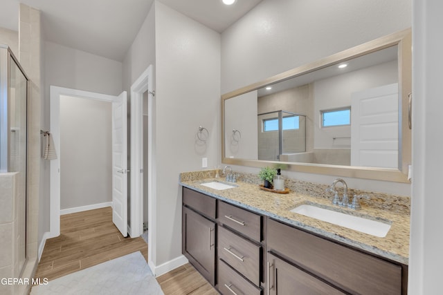 13676 Lago Vista Ave, Horizon City, TX 79928 - full bath with a stall shower, double vanity, wood finished floors, and recessed lighting