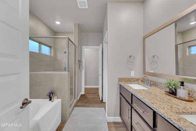13676 Lago Vista Ave, Horizon City, TX 79928 - bathroom with double vanity, a stall shower, a bath, and baseboards
