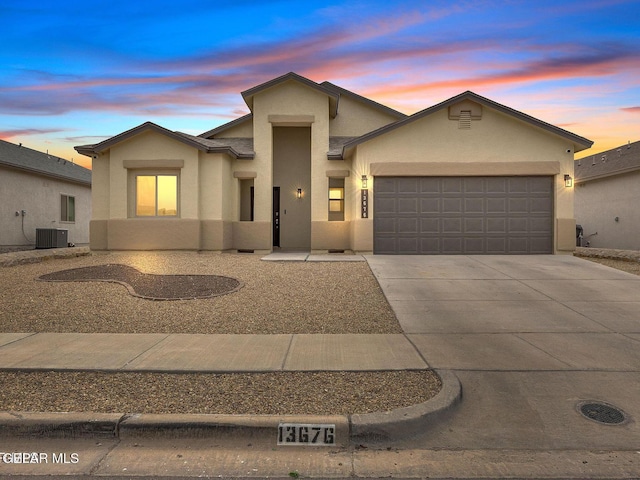 13676 Lago Vista Ave, Horizon City, TX 79928 - view of front of house featuring stucco siding, a garage, concrete driveway, and central air condition unit