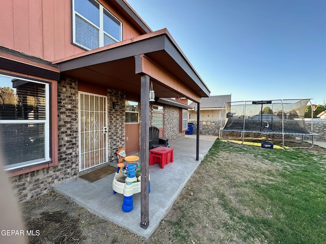 11048 Nathan Bay Dr, El Paso, TX 79934 - view of yard featuring a trampoline and a patio area