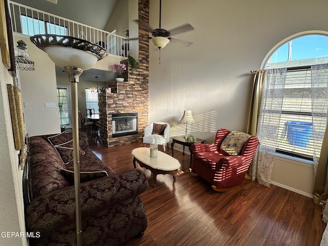 11048 Nathan Bay Dr, El Paso, TX 79934 - living area with a ceiling fan, wood finished floors, plenty of natural light, a stone fireplace, and a towering ceiling