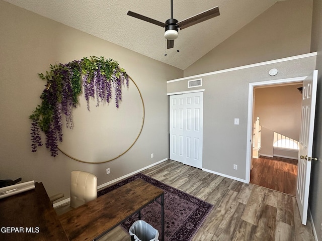 11048 Nathan Bay Dr, El Paso, TX 79934 - living area with wood finished floors, a ceiling fan, a textured ceiling, lofted ceiling, and baseboards