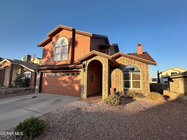 11048 Nathan Bay Dr, El Paso, TX 79934 - view of front facade with concrete driveway, a chimney, an attached garage, and central AC