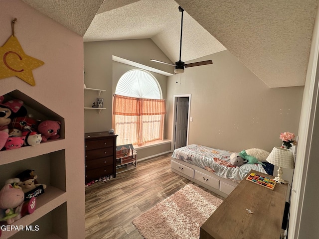 11048 Nathan Bay Dr, El Paso, TX 79934 - bedroom with lofted ceiling, a textured ceiling, wood finished floors, and a ceiling fan