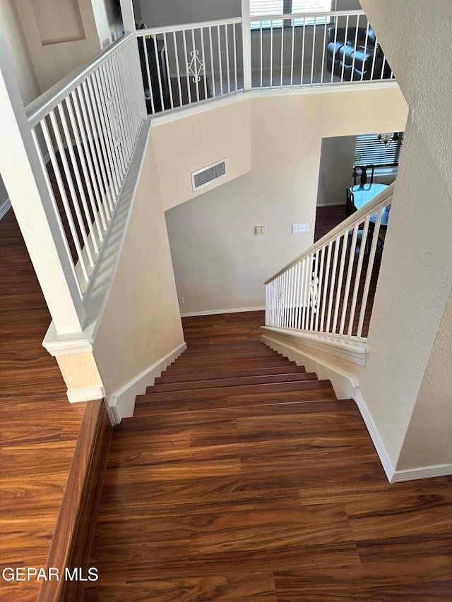 11048 Nathan Bay Dr, El Paso, TX 79934 - stairs with wood finished floors and baseboards