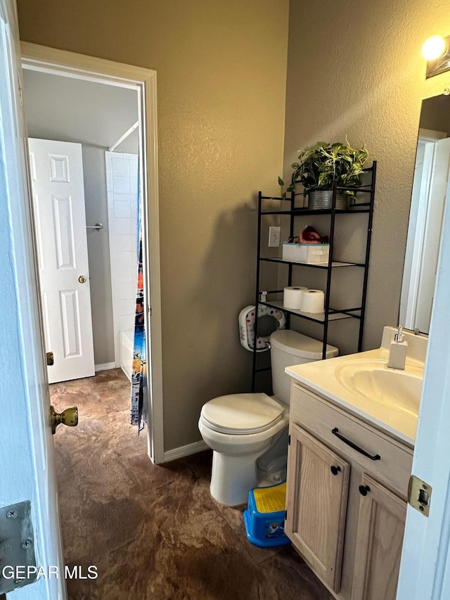 11048 Nathan Bay Dr, El Paso, TX 79934 - full bathroom with a textured wall, vanity, toilet, and baseboards