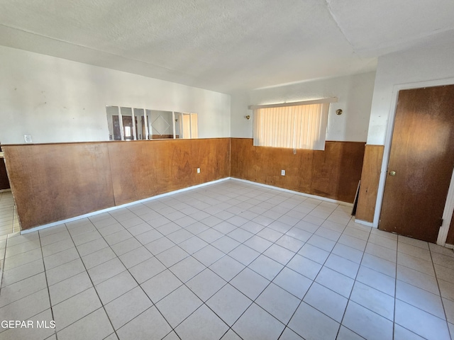 371 Medina St, El Paso, TX 79905 - empty room with wainscoting, wood walls, and a textured ceiling