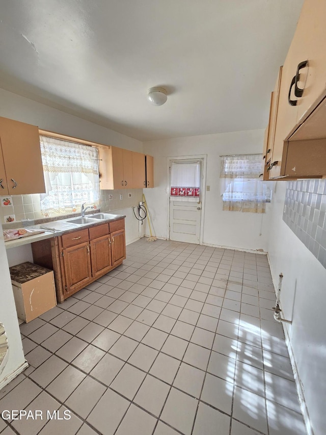 371 Medina St, El Paso, TX 79905 - kitchen with a sink, light tile patterned flooring, decorative backsplash, and light countertops