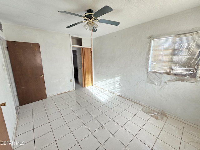 371 Medina St, El Paso, TX 79905 - unfurnished bedroom featuring tile patterned flooring, ceiling fan, and a textured ceiling