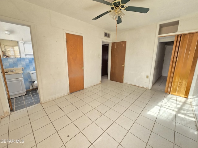 371 Medina St, El Paso, TX 79905 - unfurnished bedroom with a sink, light tile patterned flooring, ceiling fan, and connected bathroom